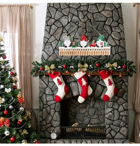 Detail of wooden Christmas advent calendar with gnomes and 24 clips on a fireplace
