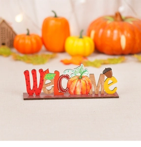 Macro detail of Welcome wooden sign with autumn pumpkin and fall leaf on a rustic base