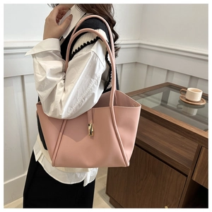 Vista lifestyle di una grande borsa tote in pelle rosa con fibbia in metallo dorato