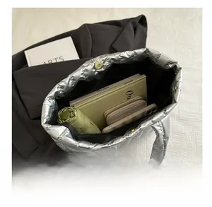 Top view of silver quilted tote bag showing spacious interior with daily essentials