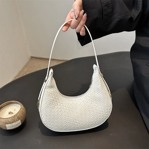 Minimalist white woven half-moon shoulder bag with elegant silver hardware and curved handle