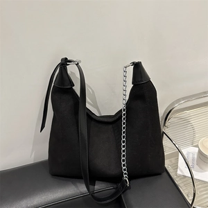 Minimalist black soft leather hobo bag with adjustable strap and silver chain detail