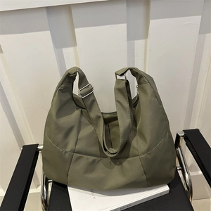Olive green quilted nylon tote bag with adjustable strap and large capacity