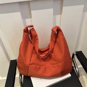 Fashionable orange large capacity nylon tote bag with adjustable strap and silver metal hardware