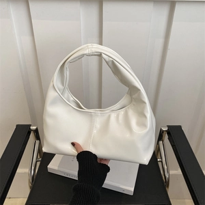 Minimalist white patent leather hobo shoulder bag with a sleek glossy finish and top handle