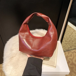 Chic dark red leather hobo handbag with irregular patchwork and glossy texture