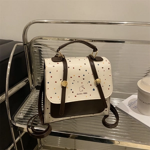 Retro polka dot backpack for women with flap closure and colorful patterned leather finish