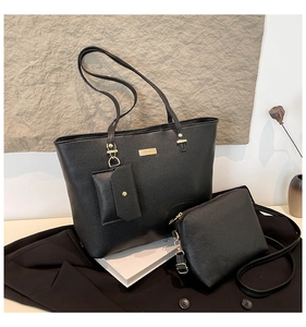 Detailed view of the 3-piece black tote bag set with textured leather and gold hardware