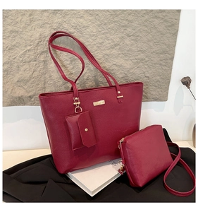 Burgundy three-piece set with tote, crossbody bag and pouch in lychee grain texture