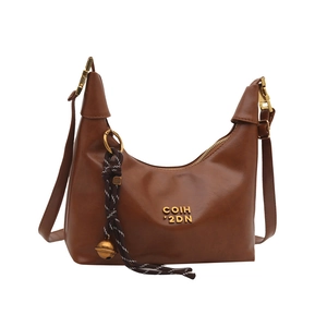Vintage caramel brown crescent hobo bag with braided charm and gold hardware