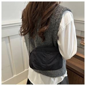 Black nylon square crossbody bag shown on model for daily casual outfit inspiration