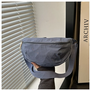 Detailed view of the gray-blue nylon crescent bag showing the adjustable shoulder strap