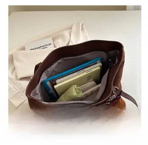 Detail view of large brown vintage tote bag showing spacious interior for daily essentials