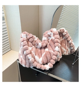 Close-up of pink and white plush tote bag with unique bubble texture and fur balls