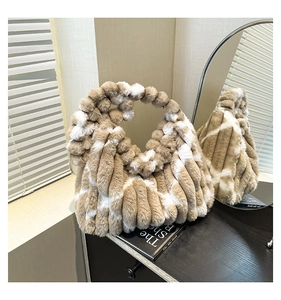 Detail of khaki and white striped faux fur tote bag with plush ribbed texture