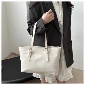 Minimalist white faux suede tote bag with letter print and adjustable strap detail