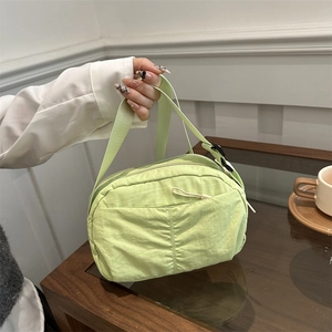 Light green nylon crossbody bag for women with drawstring pocket and wide strap