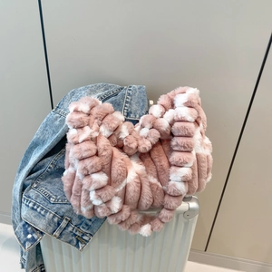 Pink and white chunky knit plush tote bag for women placed on a stylish suitcase