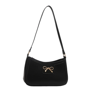 Chic black crescent underarm bag with a golden bow buckle on a clean white background
