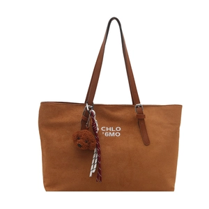 Brown matte suede tote bag with shoulder strap and a cute bear pendant decoration