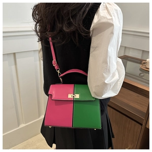Detail of color-block Kelly bag in magenta and green with gold twist-lock closure