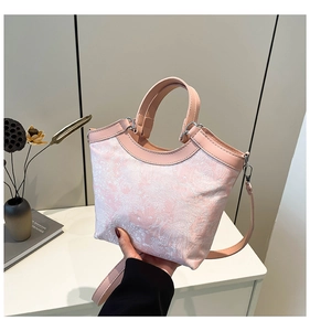 Detailed view of the pink jacquard texture and PU leather straps of the bucket bag