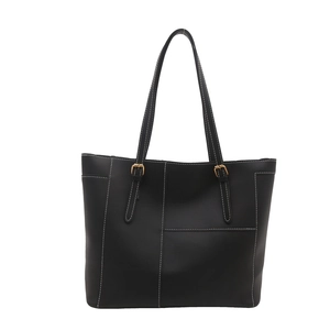 Large black tote bag with white stitching and gold buckles for women in spring 2025