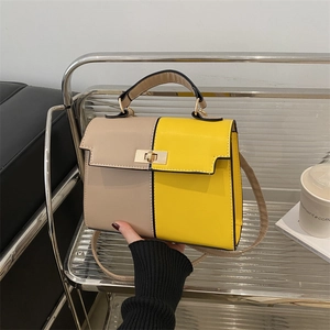 Two-tone Kelly style handbag in beige and yellow with metal lock and top handle