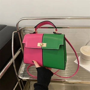 Pink and green contrast trapezoid Kelly bag with golden twist lock and top handle