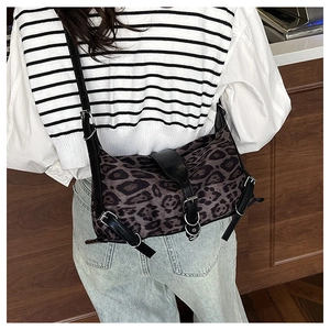 Vista posteriore di una modella con borsa a tracolla leopardata e cinturini in pelle nera