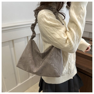 Detail of grey marble-patterned cloud bag with pleated shoulder strap for women