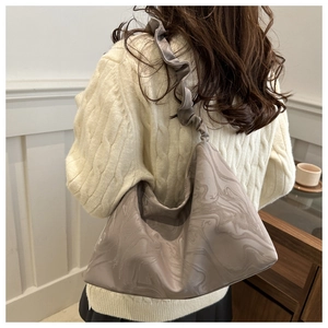 Détail du sac cabas taupe avec motif marbré et bandoulière à volants plissés