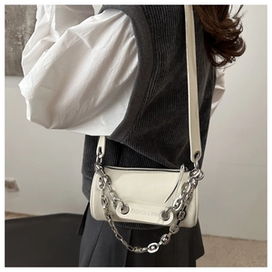 Detail of cream white leather cylindrical bag with silver chain and Fashion & BMH text