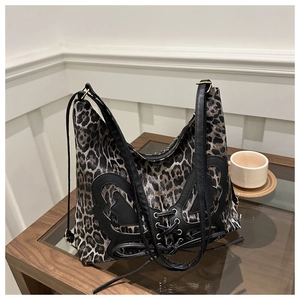 Detail of leopard print tote bag with black leather butterfly bow and tie detail