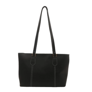 Classic black leather tote bag with white contrast stitching and gold hardware accents
