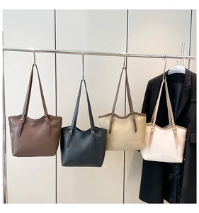 Detailed display of vintage tote bags in four colors hanging for professional office wear