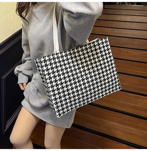 Classic black and white houndstooth pattern detail on a large capacity tote bag