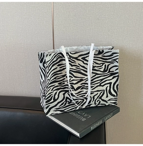 Macro view of large canvas tote bag featuring stylish black and white zebra print patterns