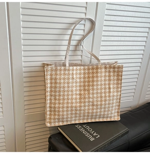 Detailed view of large houndstooth canvas tote bag texture on minimalist home decor