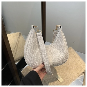 Detail of white crocodile pattern crescent bag with premium gold metal hardware hooks