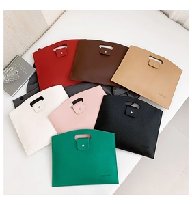 Flat lay of colorful minimalist leather tote bags with snap closure and cutout handles