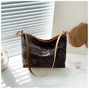 Gros plan sur le sac fourre-tout léopard en cuir synthétique brillant avec bandoulière