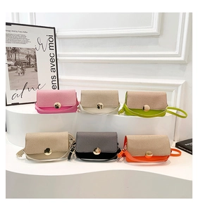 Detail view of multi-color crossbody bags with woven texture and gold metal buckle