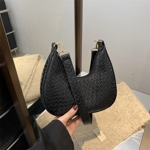 French crescent shoulder bag in black crocodile embossed leather with gold buckle