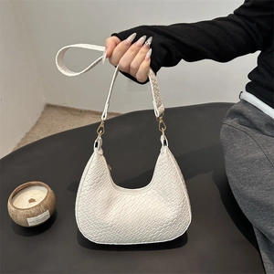French weave crescent shoulder bag in white crocodile pattern with gold hardware details