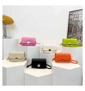 Group view of minimalist matte leather crossbody bags with round metal buckles in six colors