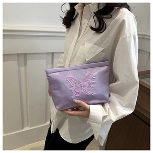 Detailed embroidery of pink butterfly on lavender satin handbag for elegant evening look