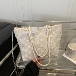 Straw tote bag with white flower embroidery and large lace bow for summer beach