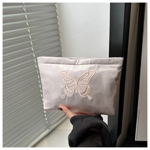 Detailed embroidery of butterfly pattern on satin fabric cosmetic makeup pouch