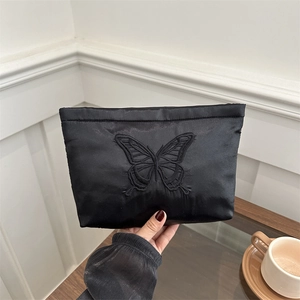 Elegant black satin clutch bag featuring exquisite butterfly embroidery and silk texture